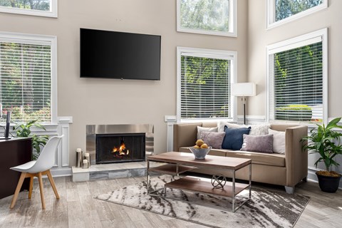 a living room with a fireplace and a tv on the wall